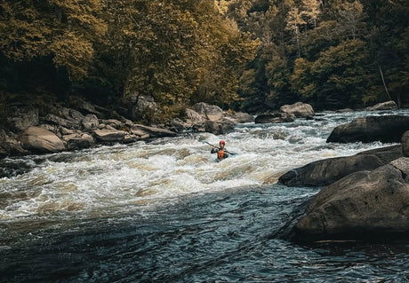 A view of a kayaker in the Youghiogheny River in Ohiopyle State Park during late summer captured by Tom Bush @tb4hisflory.