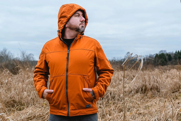 A Photo of a man in an orange jacket looking to the side