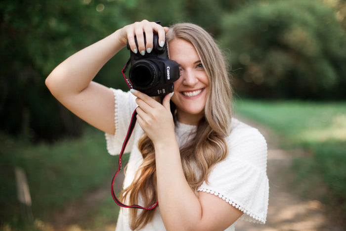 A photographer smiling while taking a photo