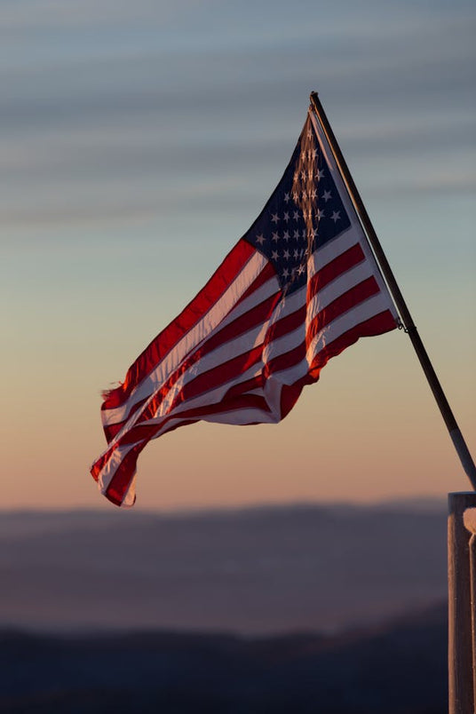 An American Flag waving in the wind during sunset